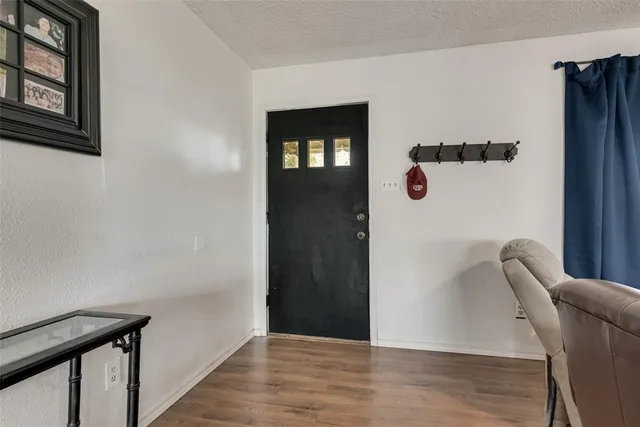a view of an entryway with wooden floor