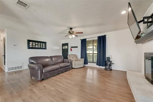 a living room with furniture and wooden floor