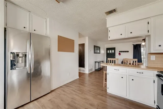 a kitchen with white cabinets stainless steel appliances and sink