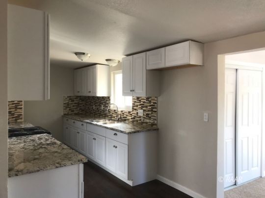 1505 South McCall Street Ridgecrest, CA 93555 - Photo 3 of 17 a kitchen with a sink stove and refrigerator