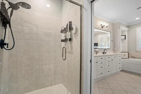 a bathroom with a double vanity sink a mirror and shower