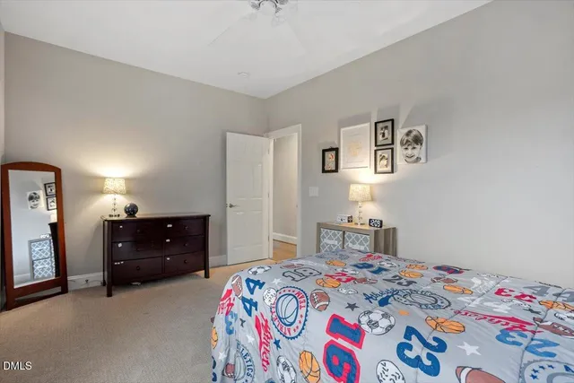 a bedroom with a bed and a dresser in it