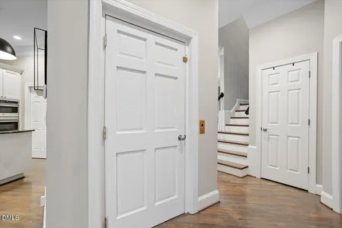 a view of a hallway with wooden floor