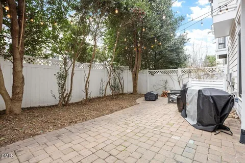 a view of a backyard with chairs and a fire pit