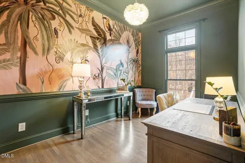 a view of a dining room with furniture and chandelier