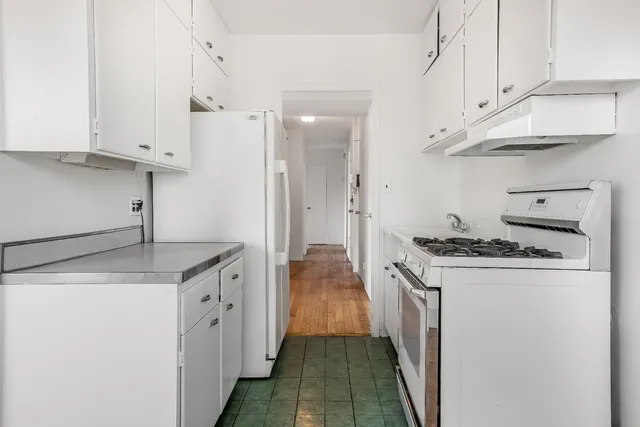 a kitchen with stainless steel appliances granite countertop a stove and a refrigerator