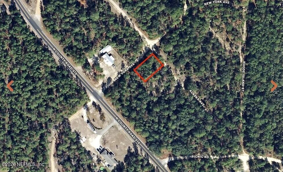 an aerial view of a house with a tree