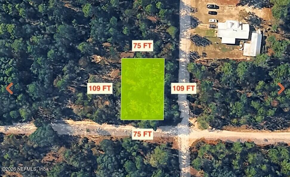 0 Alaska Avenue Interlachen, FL 32148 - Photo 3 of 11 a green building with trees in the background