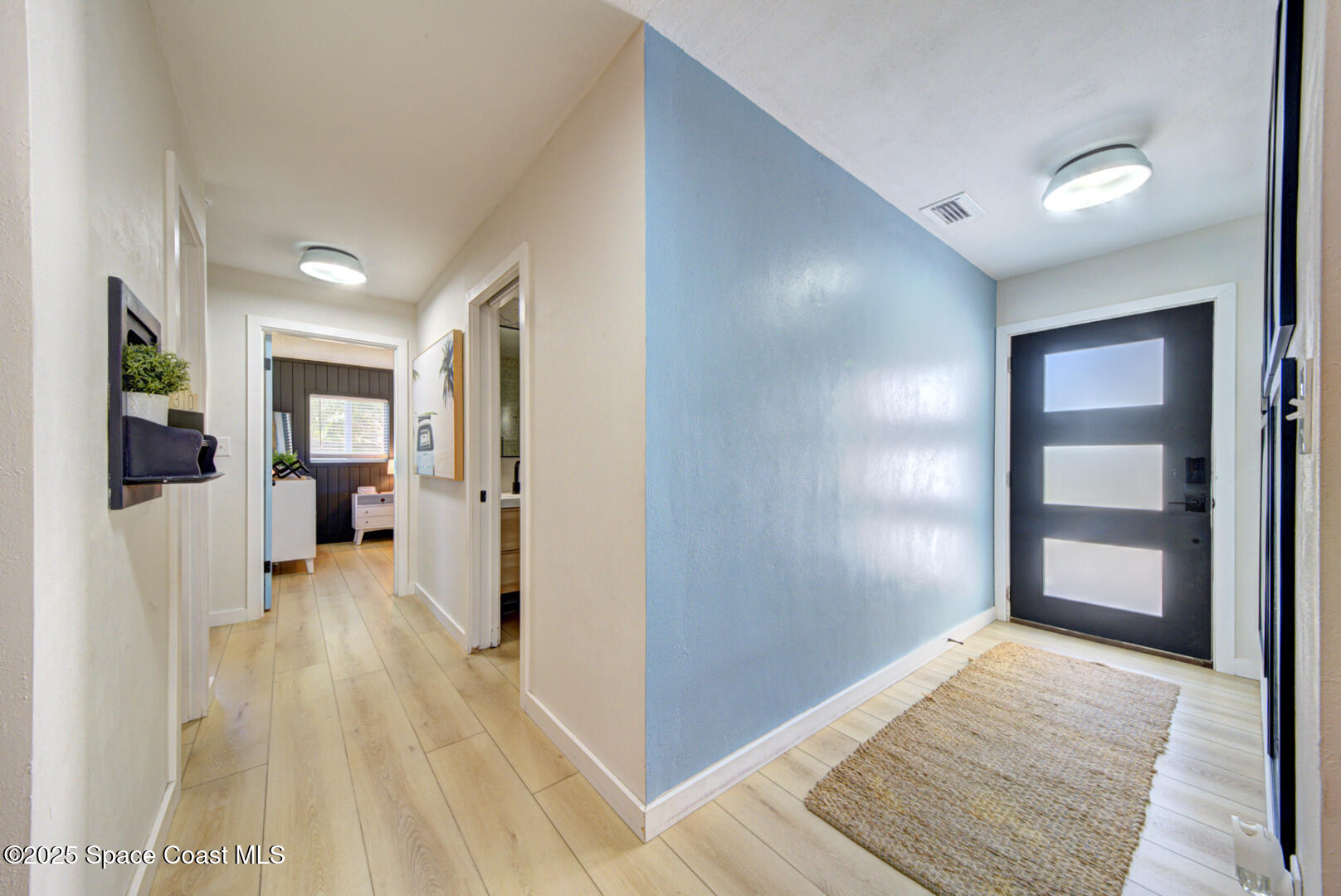 911 Bali Road Cocoa Beach, FL 32931 - Photo 25 of 66 a view of a hallway with wooden floor and closet