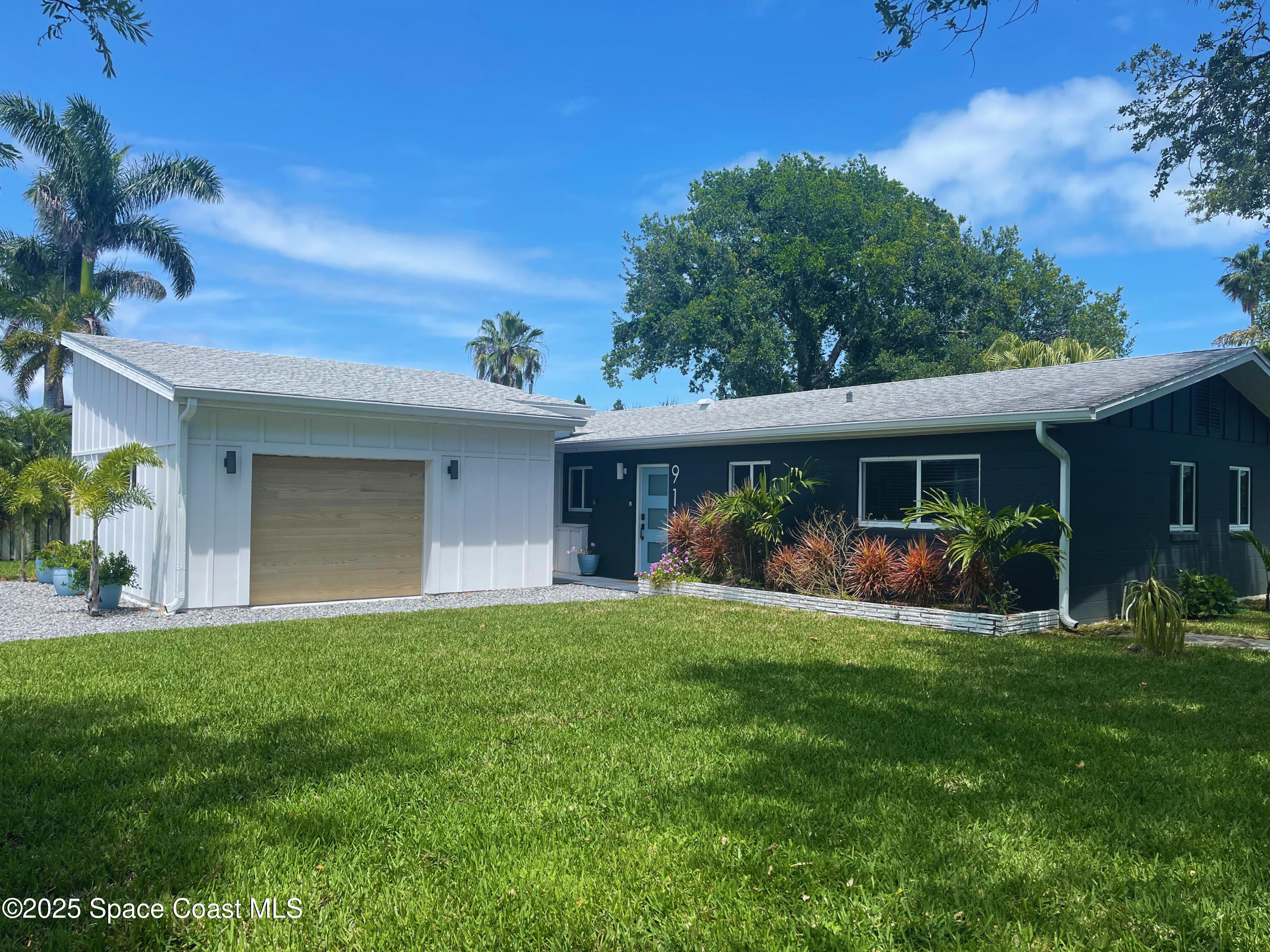 911 Bali Road Cocoa Beach, FL 32931 - Photo 3 of 66 a view of a house with a yard and porch