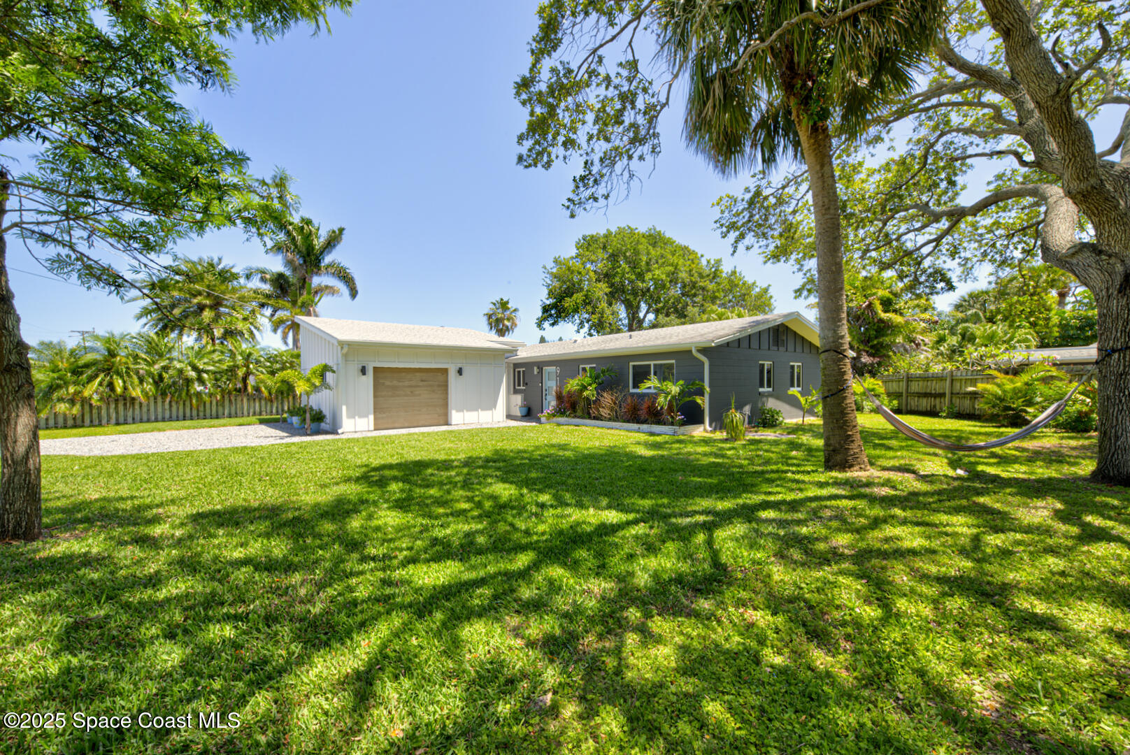 911 Bali Road Cocoa Beach, FL 32931 - Photo 33 of 66 a front view of a house with garden