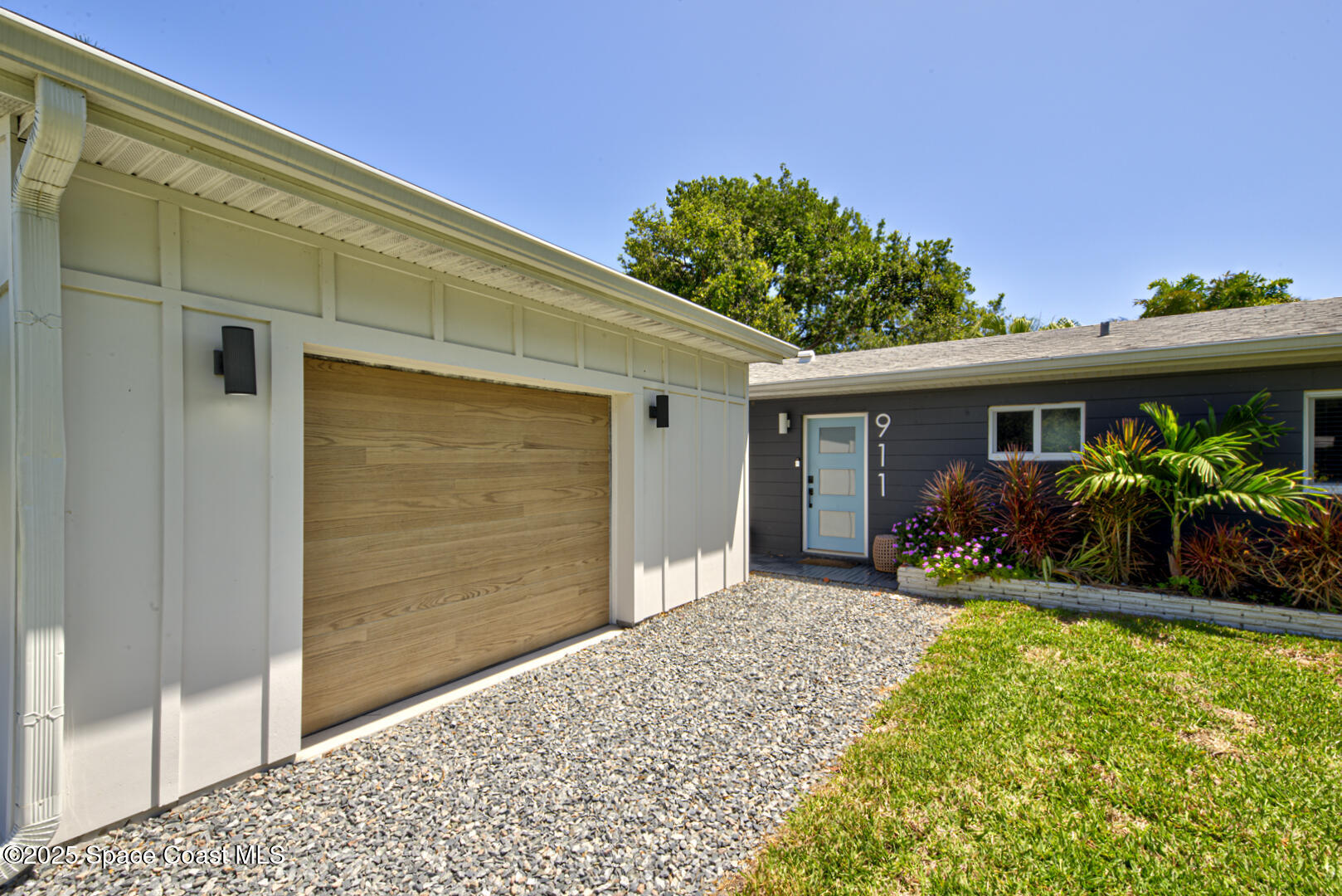 911 Bali Road Cocoa Beach, FL 32931 - Photo 36 of 66 a front view of a house with a yard