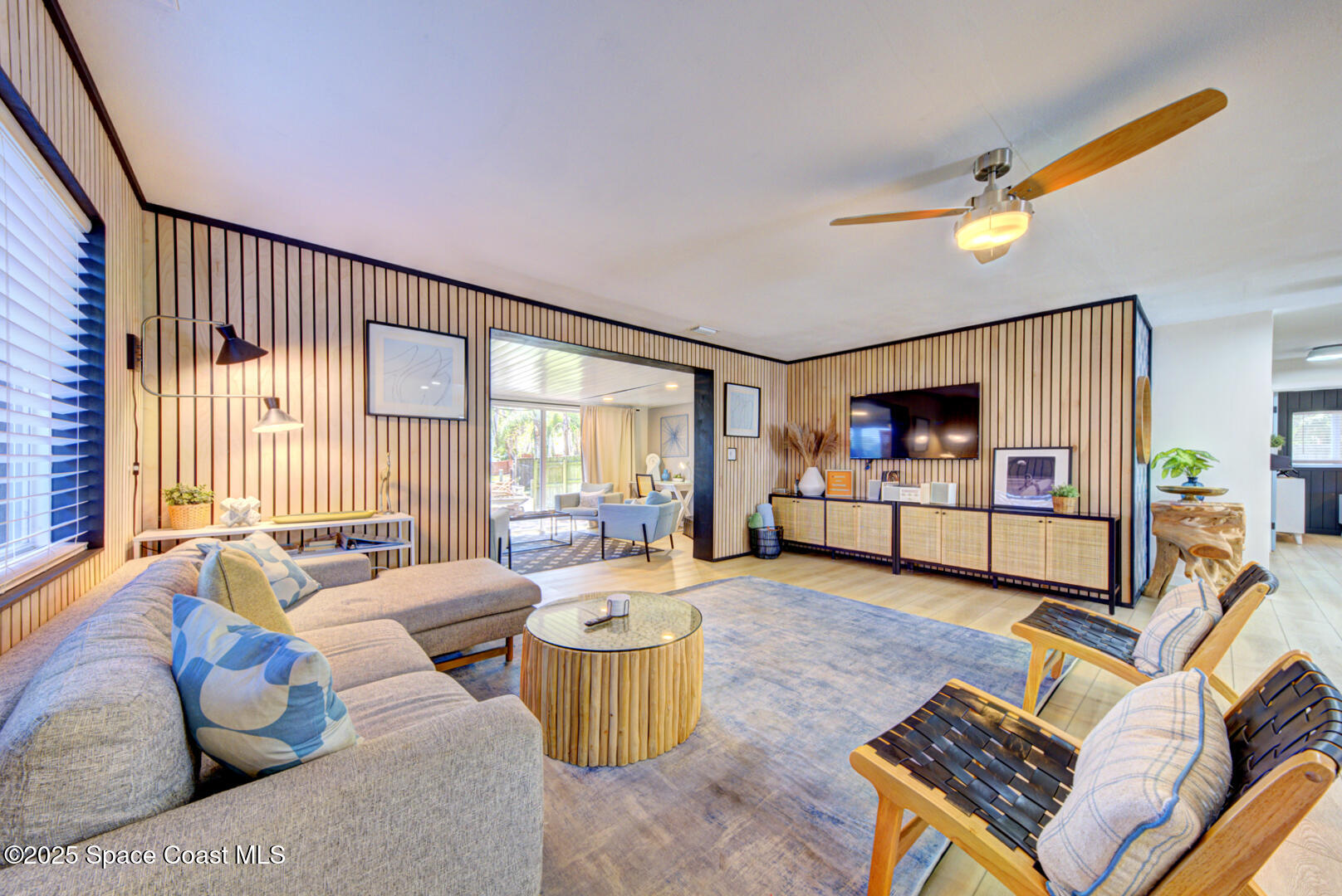 911 Bali Road Cocoa Beach, FL 32931 - Photo 49 of 66 a living room with furniture and a flat screen tv