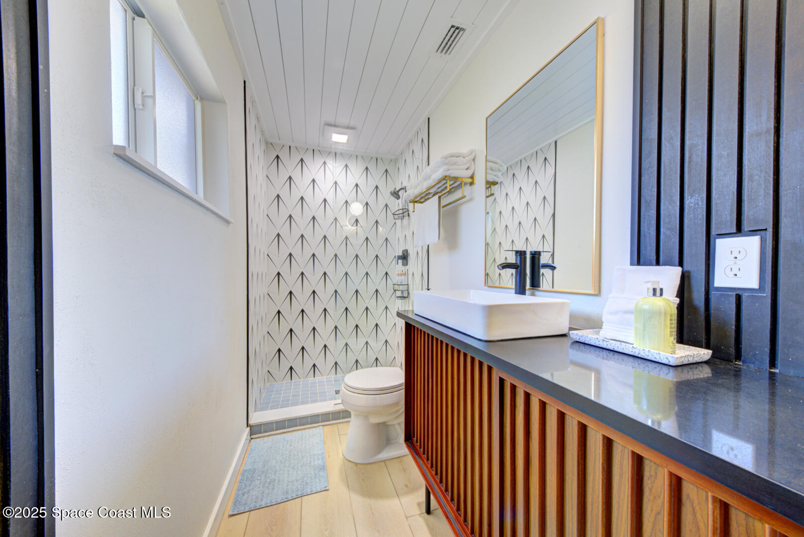 911 Bali Road Cocoa Beach, FL 32931 - Photo 54 of 66 a bathroom with a sink a toilet and shower