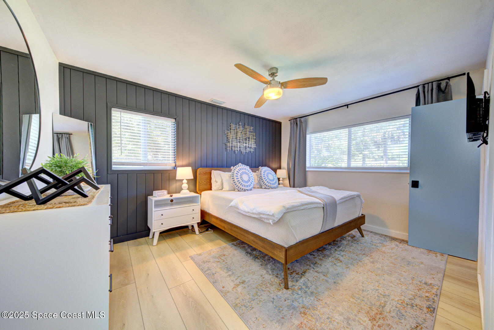 911 Bali Road Cocoa Beach, FL 32931 - Photo 55 of 66 a bedroom with a bed and a large window