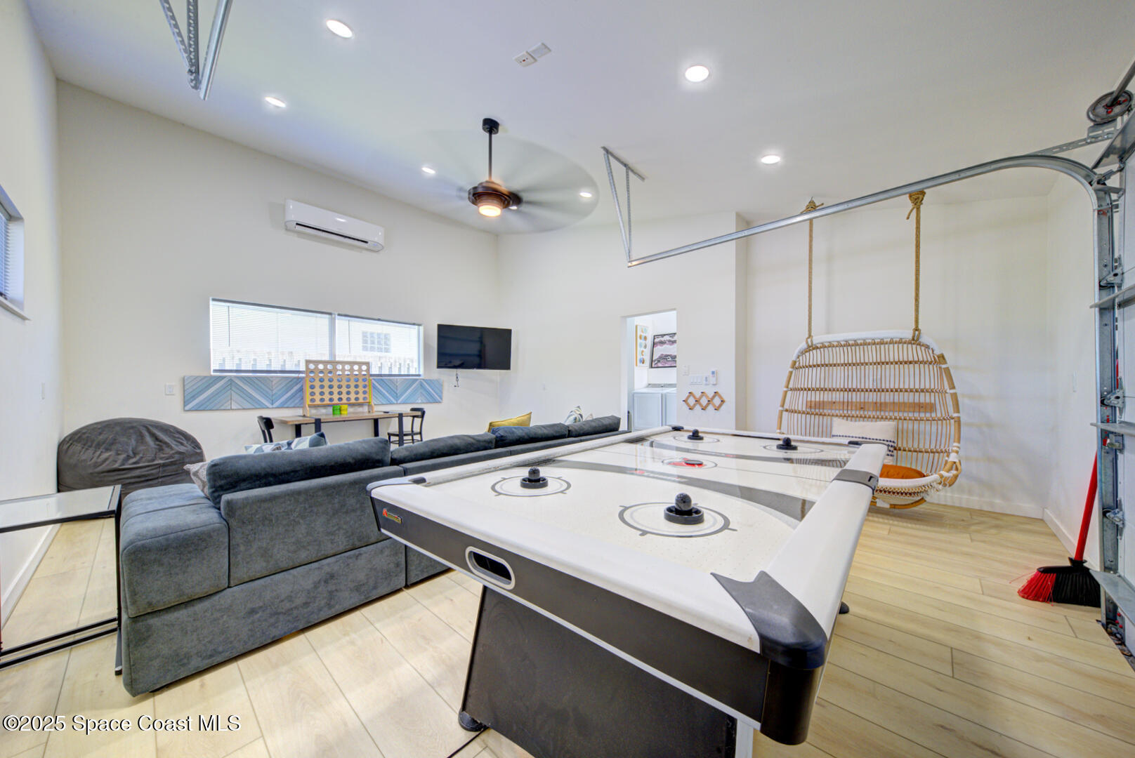 911 Bali Road Cocoa Beach, FL 32931 - Photo 58 of 66 a living room with furniture and a flat screen tv