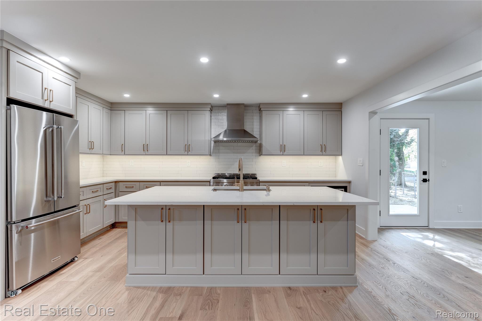 786 South Cranbrook Road Bloomfield Hills, MI 48301 - Photo 6 of 38 Kitchen with high end fridge, light wood-style floors, backsplash, recessed lighting, and gray cabinets