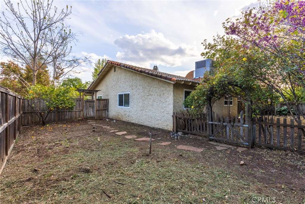 44 Forest Creek Circle Chico, CA 95928 - Photo 20 of 21 a backyard of a house with large trees and wooden fence