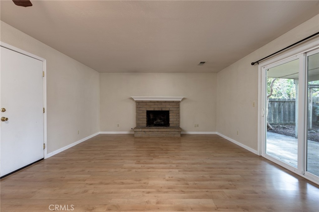 44 Forest Creek Circle Chico, CA 95928 - Photo 8 of 21 a view of empty room with wooden floor and fireplace