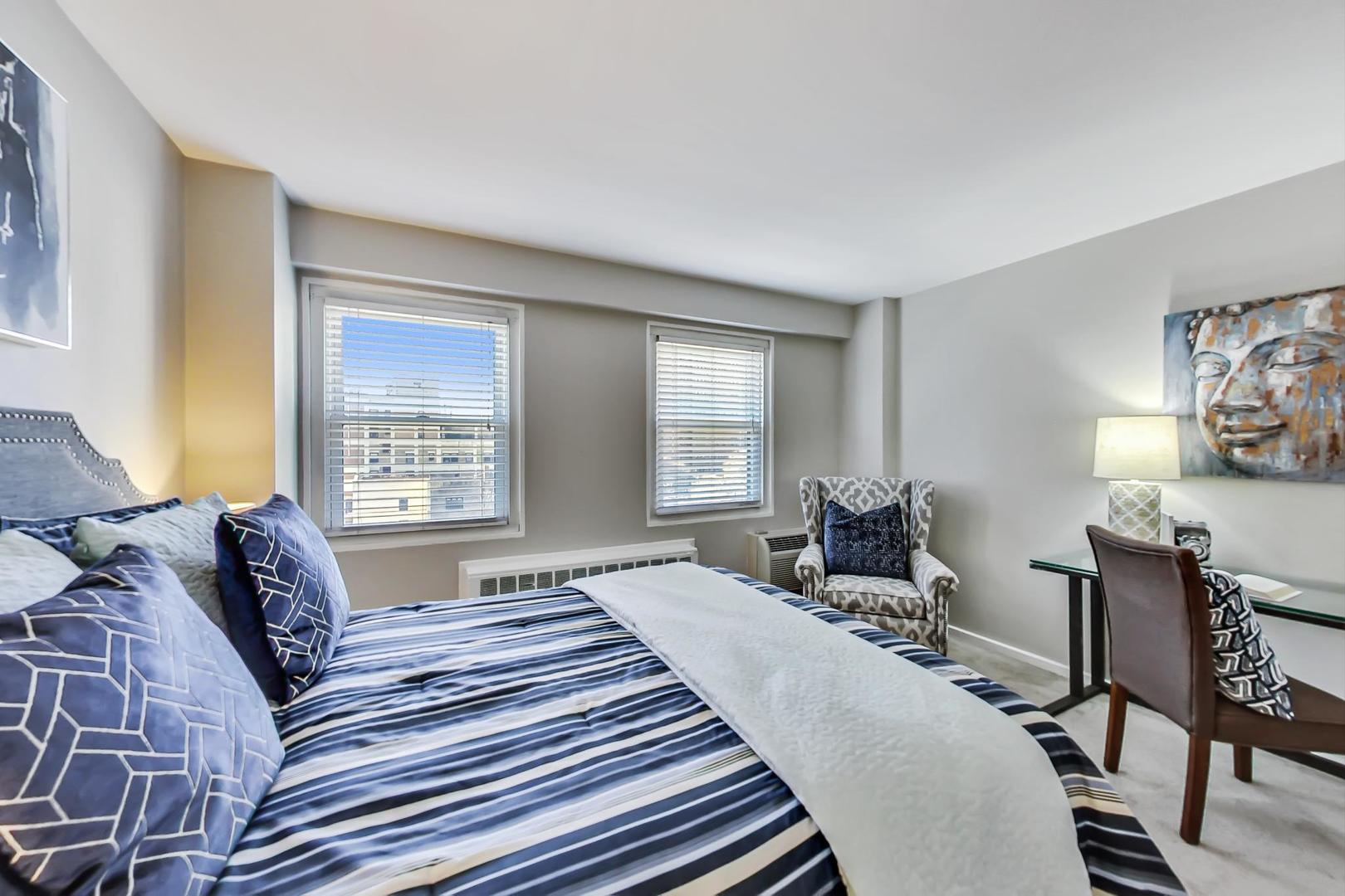 2909 North Sheridan Road, Unit 712 Chicago, IL 60657 - Photo 11 of 16 a bedroom with a bed a table and chair