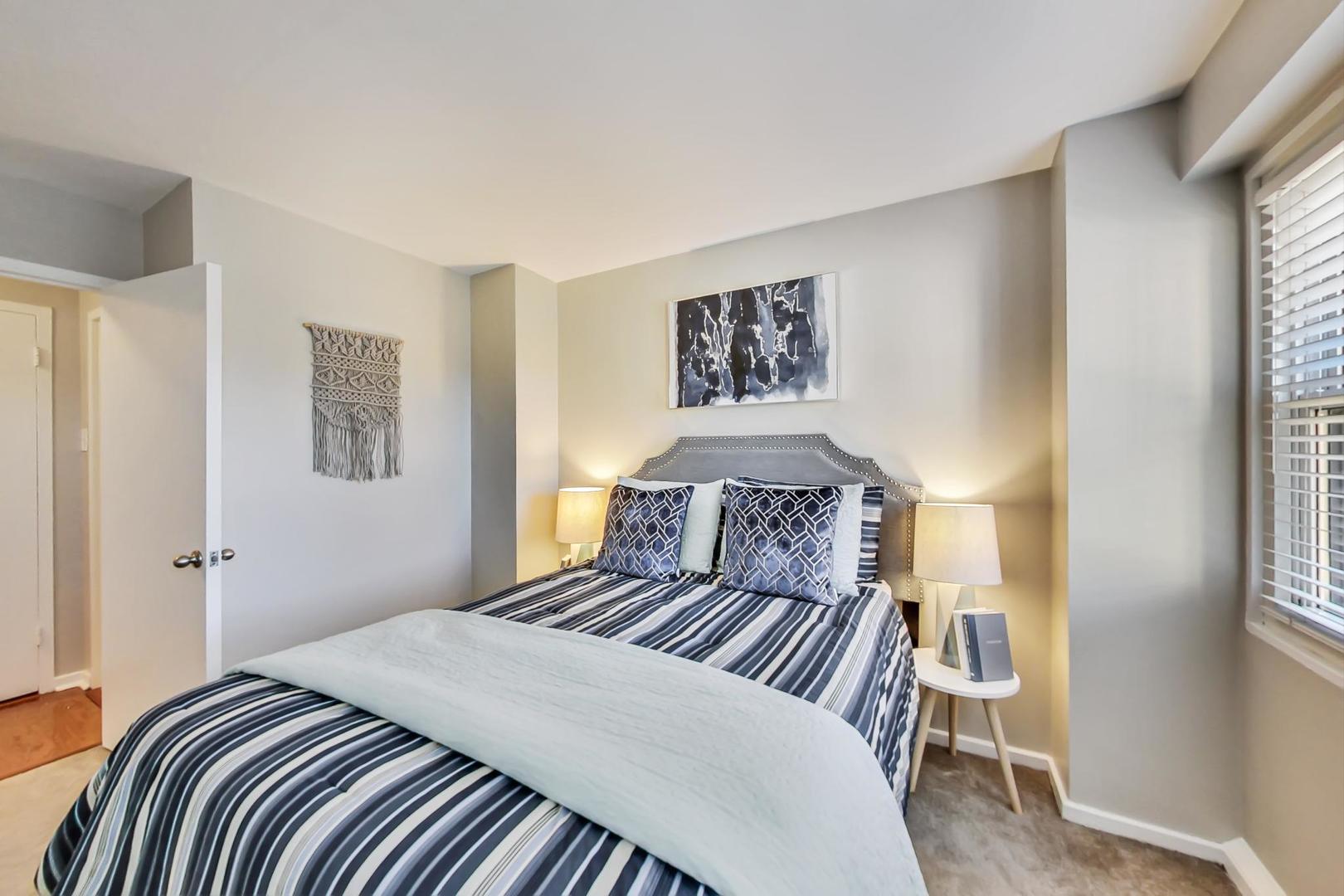 2909 North Sheridan Road, Unit 712 Chicago, IL 60657 - Photo 13 of 16 a bedroom with a large bed and a chandelier