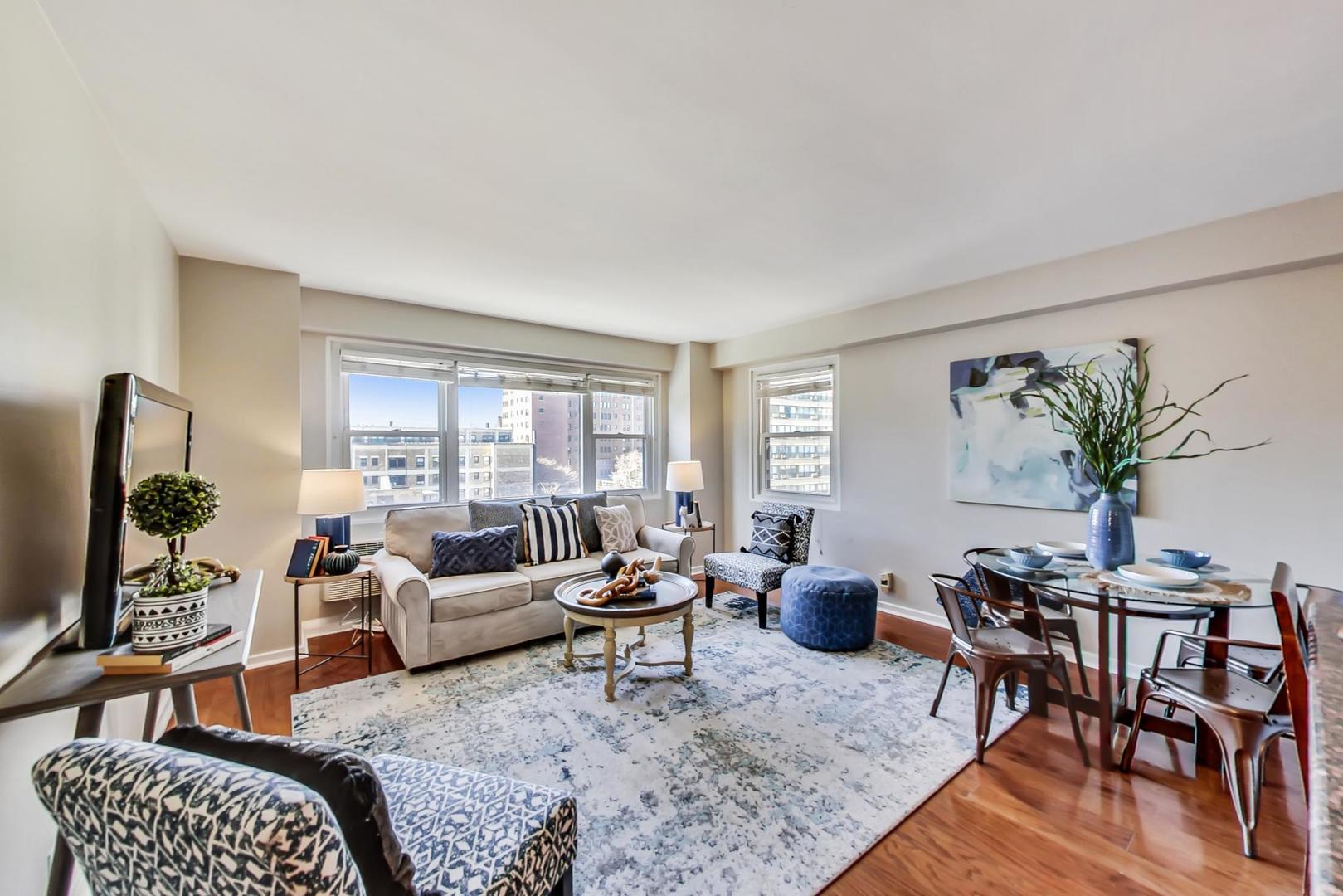 2909 North Sheridan Road, Unit 712 Chicago, IL 60657 - Photo 4 of 16 a living room with furniture a wooden floor and next to a window