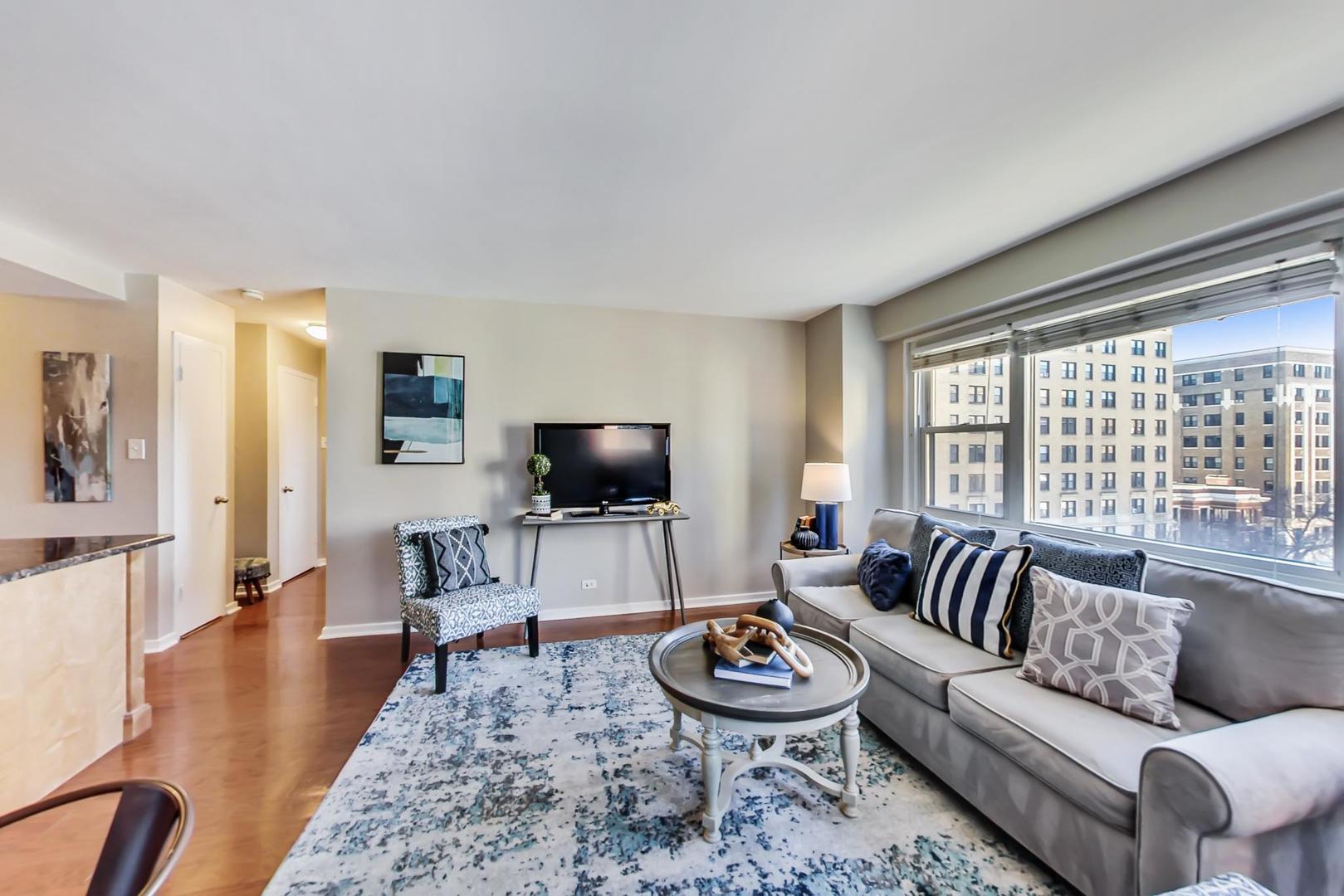 2909 North Sheridan Road, Unit 712 Chicago, IL 60657 - Photo 6 of 16 a living room with furniture and a flat screen tv