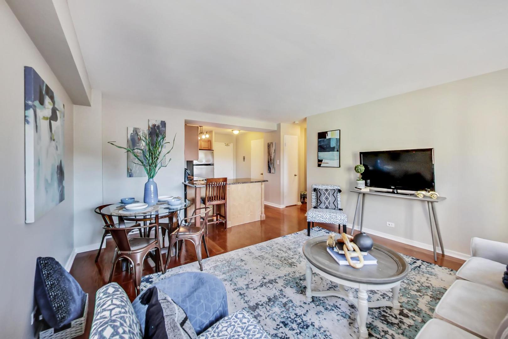 2909 North Sheridan Road, Unit 712 Chicago, IL 60657 - Photo 7 of 16 a living room with furniture and a flat screen tv