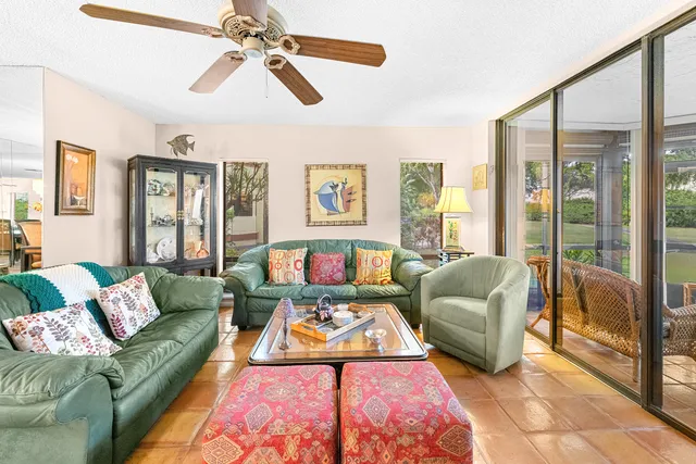 a living room with lots of furniture and view of kitchen