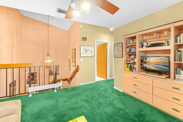 a bed room with a bed a couch and a window