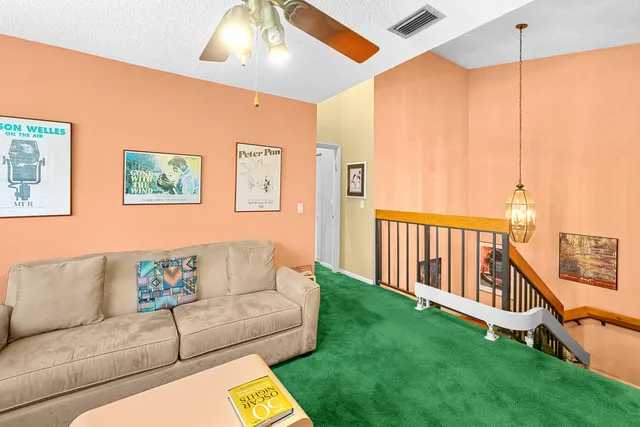 a view of a porch with furniture and floor to ceiling window