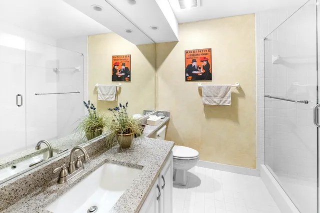 a dining room with furniture a chandelier and glass door