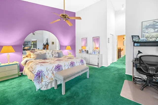 an aerial view of residential houses with outdoor space and trees