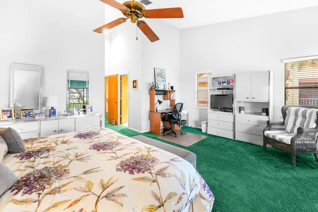 a front view of a house with a garden and trees