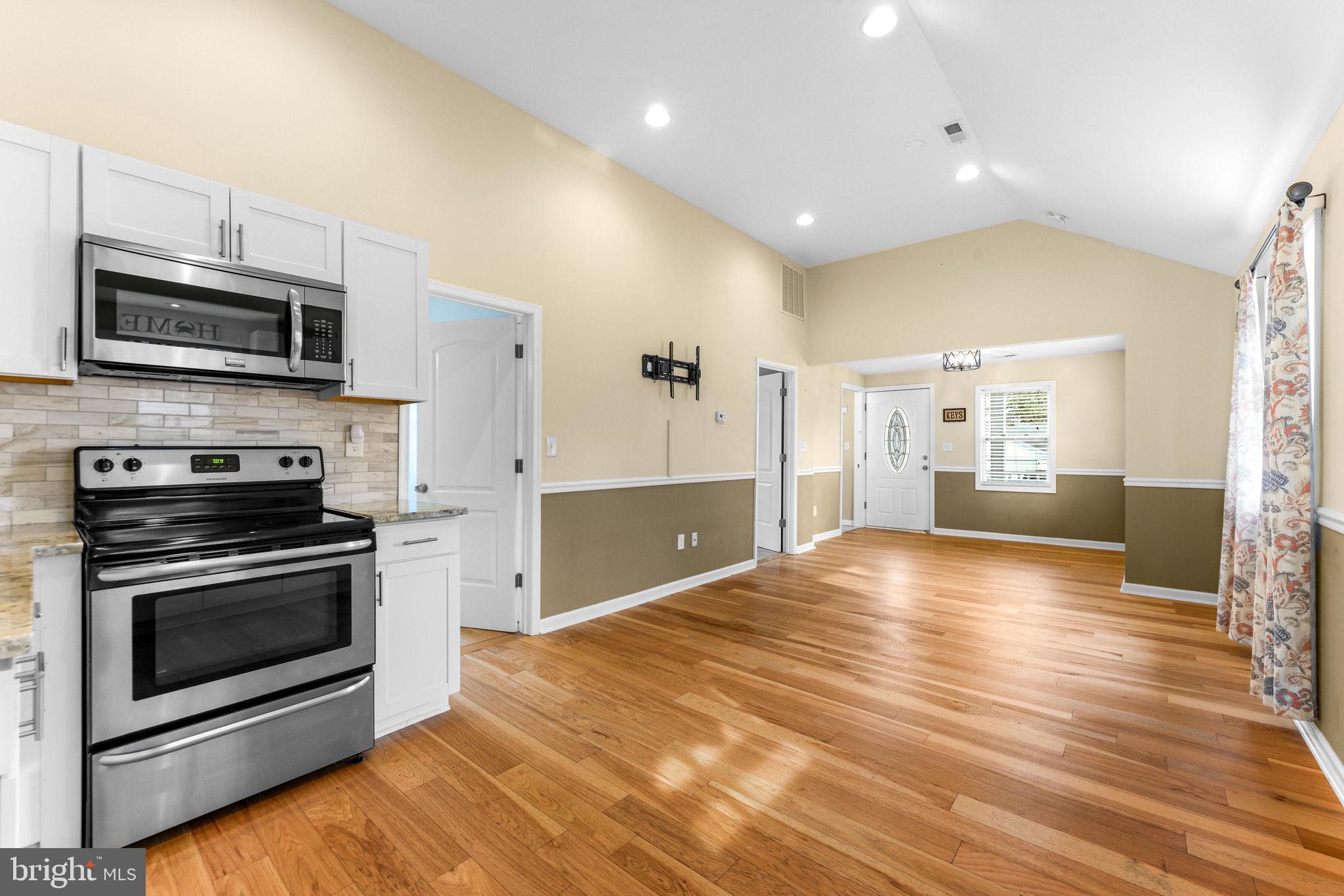 7343 Greenbank Road Baltimore, MD 21220 - Photo 16 of 46 a view of kitchen with microwave stove refrigerator and cabinets