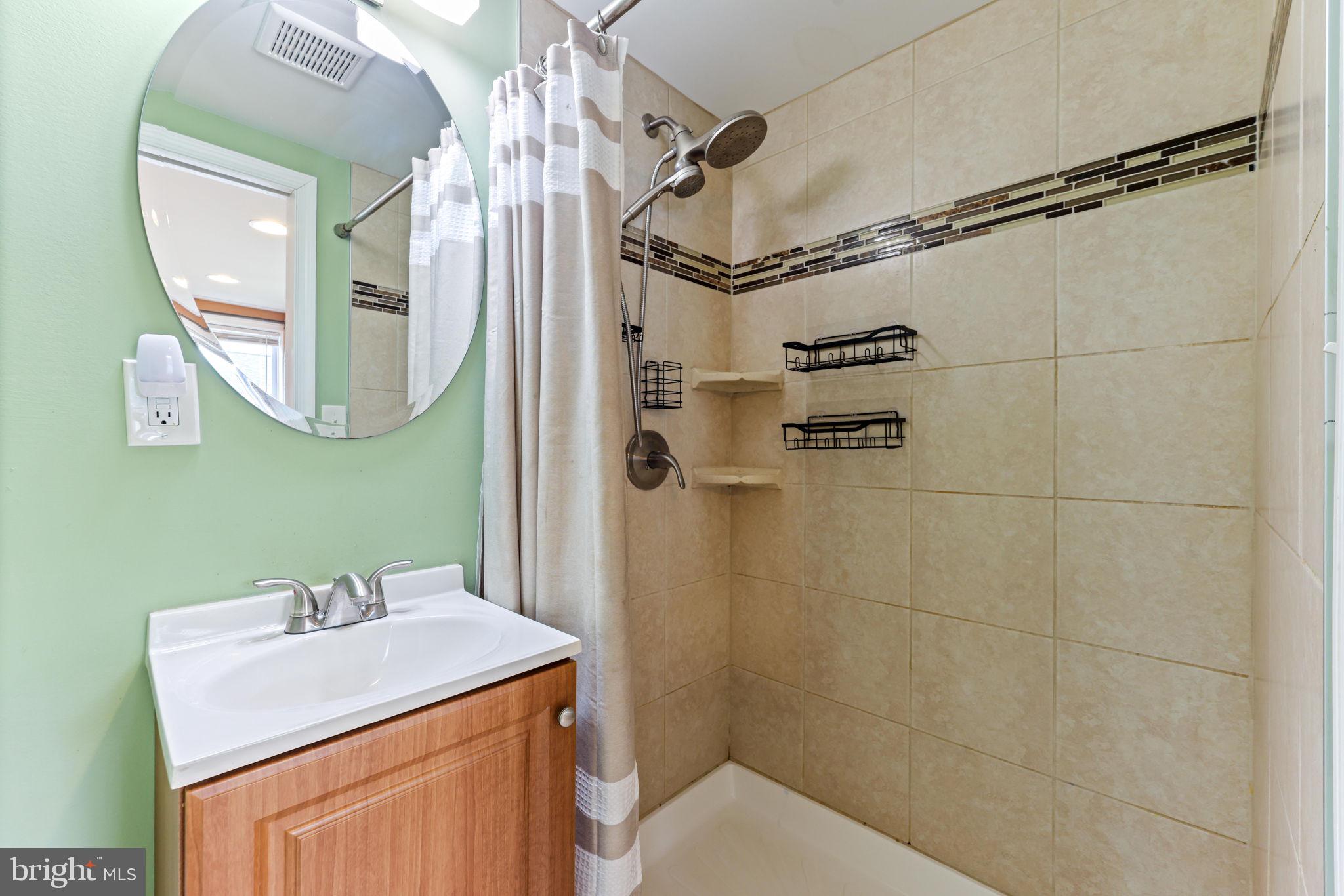7343 Greenbank Road Baltimore, MD 21220 - Photo 21 of 46 a bathroom with a sink toilet and shower