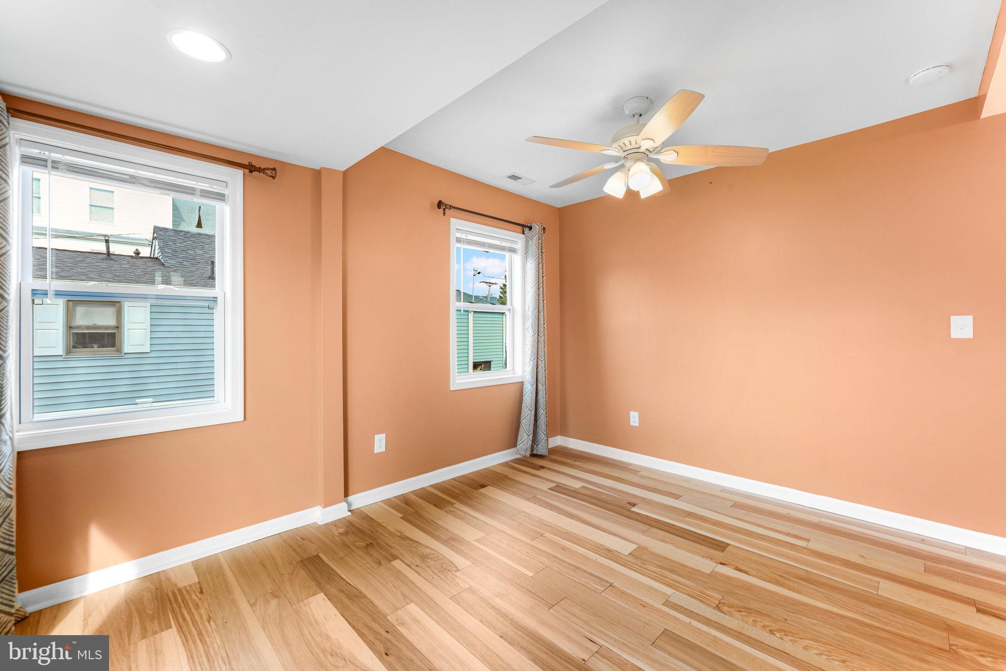 7343 Greenbank Road Baltimore, MD 21220 - Photo 22 of 46 a view of empty room with wooden floor and fan