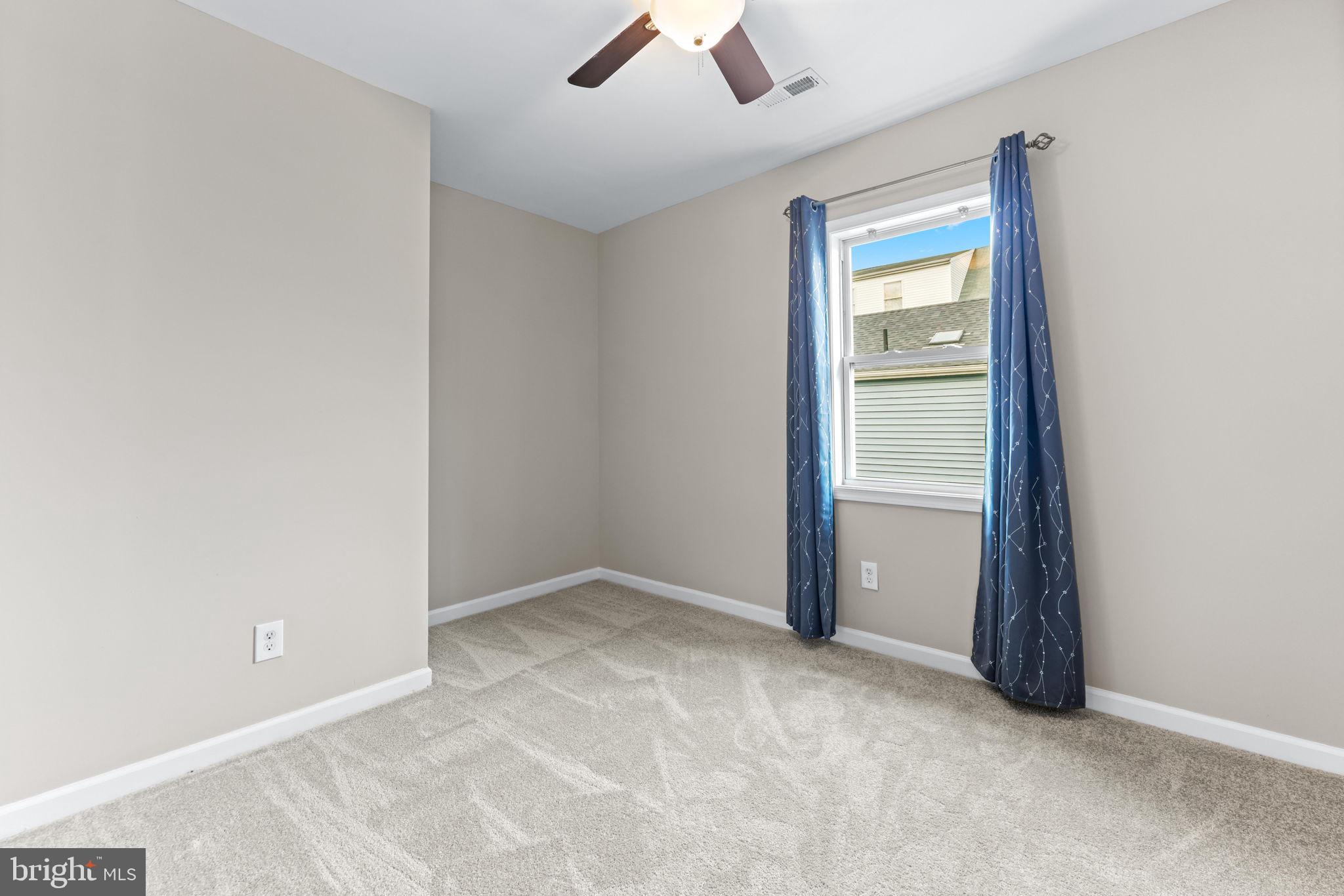 7343 Greenbank Road Baltimore, MD 21220 - Photo 30 of 46 an empty room with ceiling fan and window