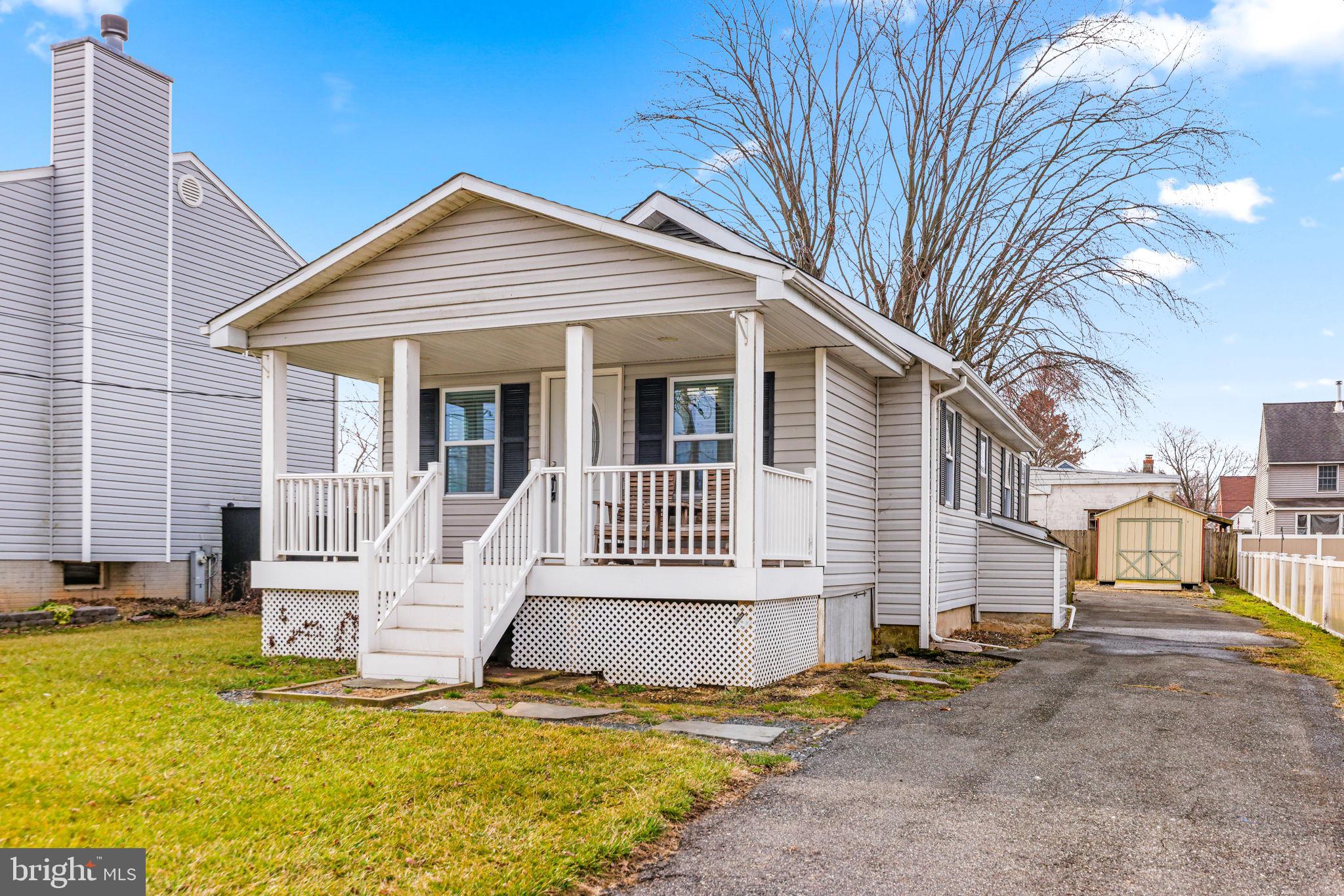 7343 Greenbank Road Baltimore, MD 21220 - Photo 4 of 46 a view of a house with a small yard and wooden fence