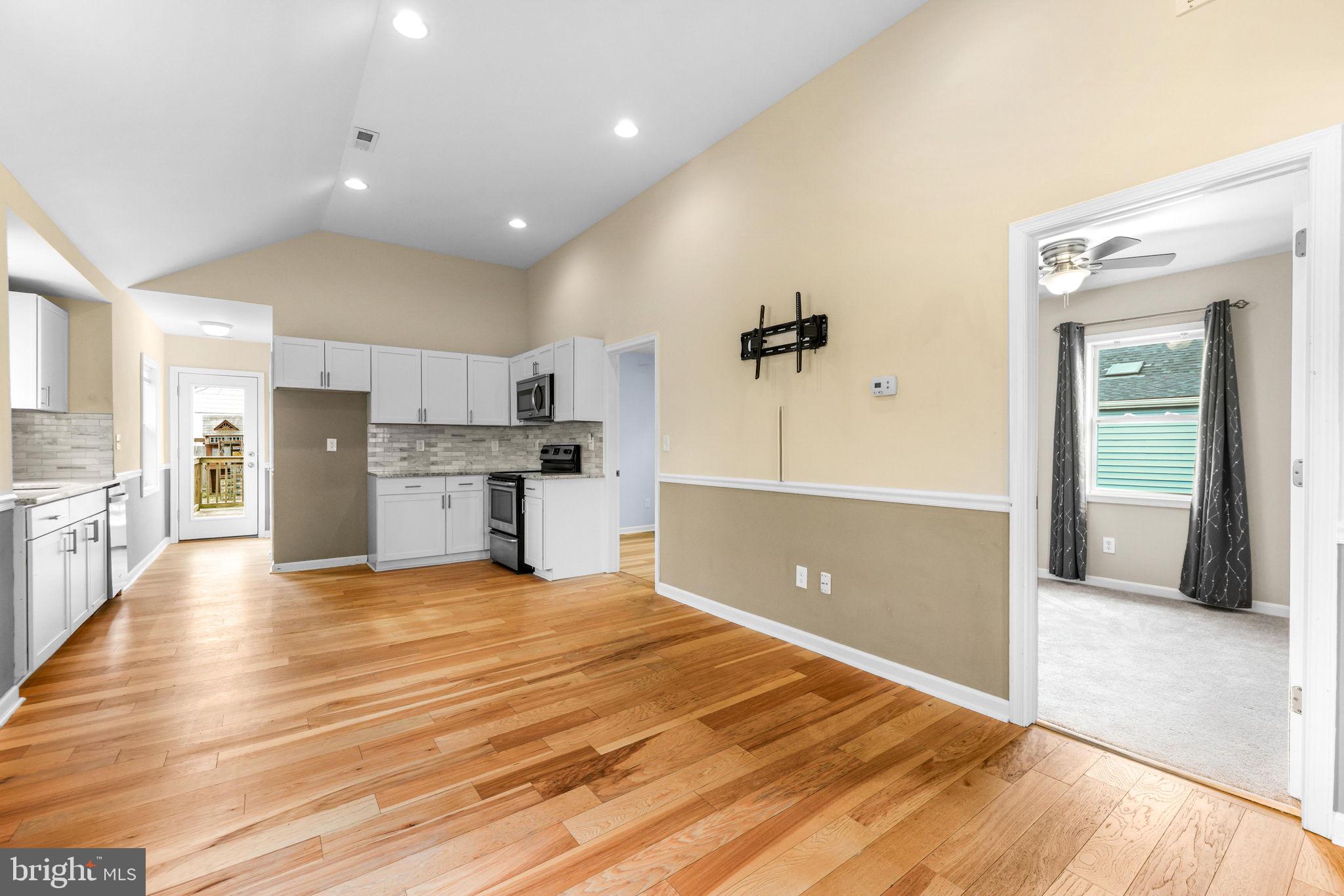 7343 Greenbank Road Baltimore, MD 21220 - Photo 8 of 46 a view of an empty room with kitchen and window