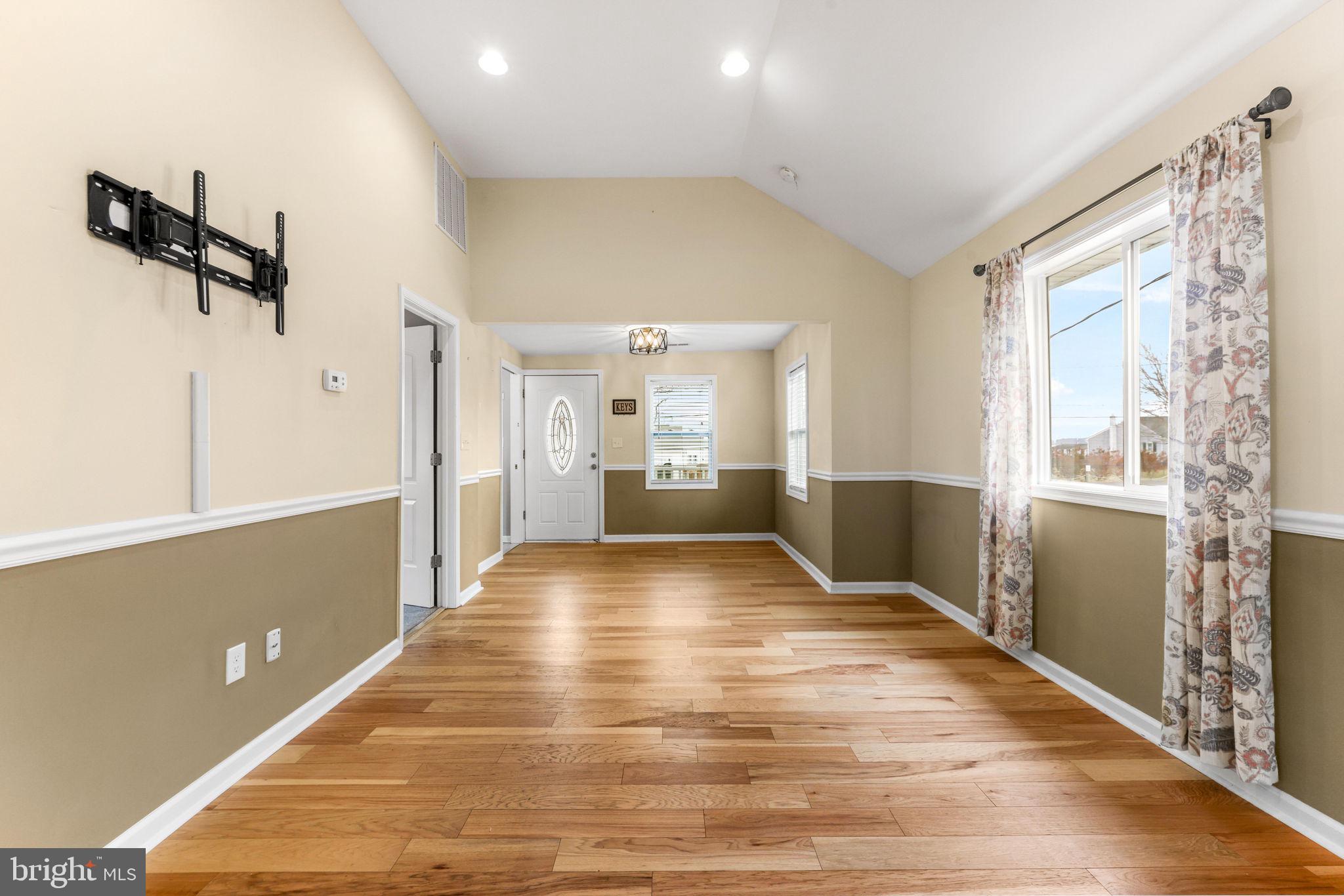 7343 Greenbank Road Baltimore, MD 21220 - Photo 10 of 46 a view of empty room with wooden floor and windows