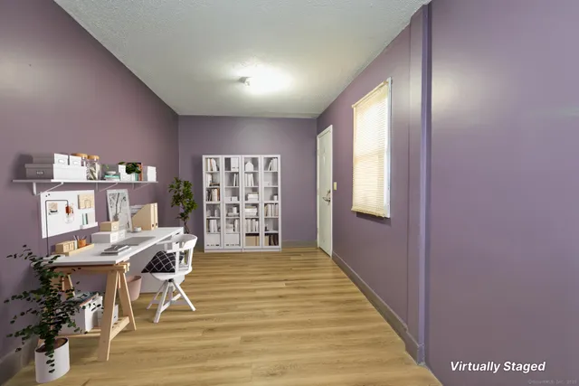 a bedroom with two beds and a flat screen tv