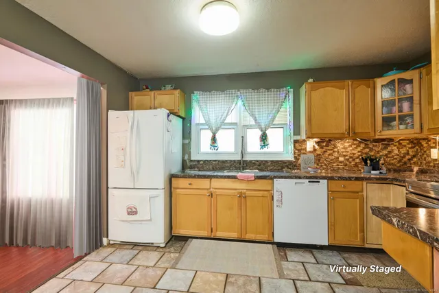 a kitchen with stainless steel appliances granite countertop a refrigerator and a stove