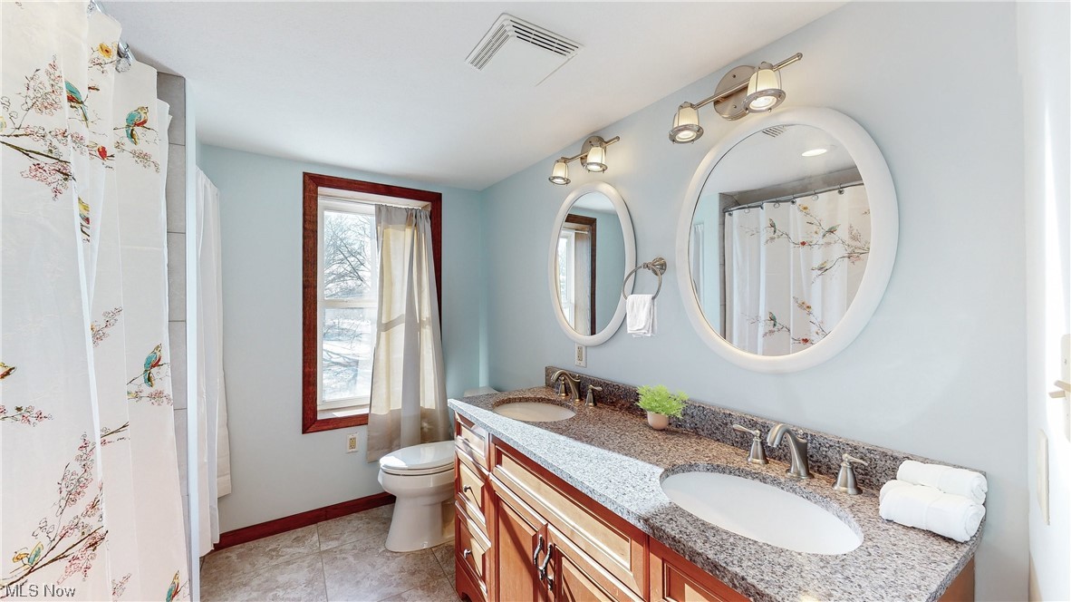 5770 Horning Road Kent, OH 44240 - Photo 32 of 50 Bathroom featuring dual sinks, tile floors, toilet, and large vanity