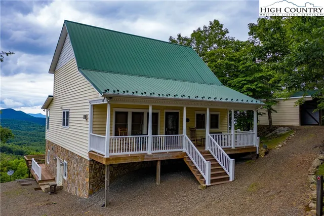 a front view of a house with a garden and deck