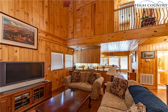 a dining room with furniture and a floor to ceiling window