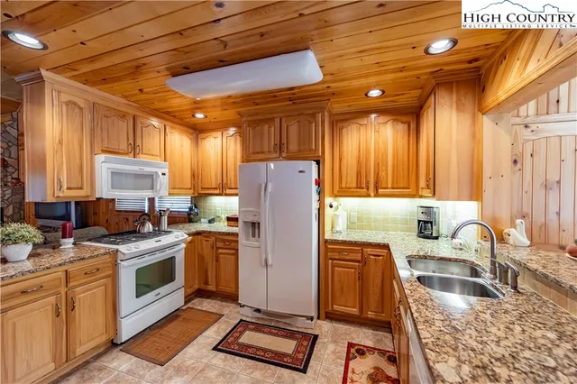 a bedroom with a bed and wooden cabinets