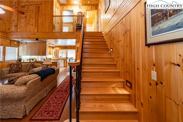 a kitchen with stainless steel appliances granite countertop a refrigerator a sink dishwasher stove and refrigerator with wooden floor