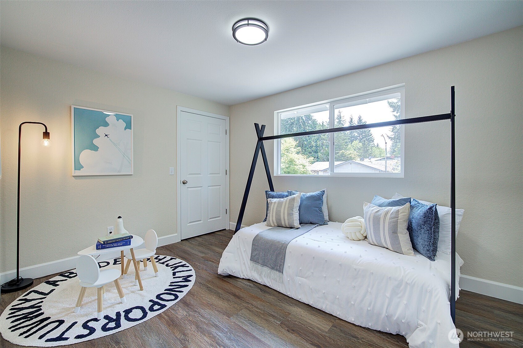 2019 181st Street Southeast Bothell, WA 98012 - Photo 13 of 23 a bedroom with a bed and a wooden floor