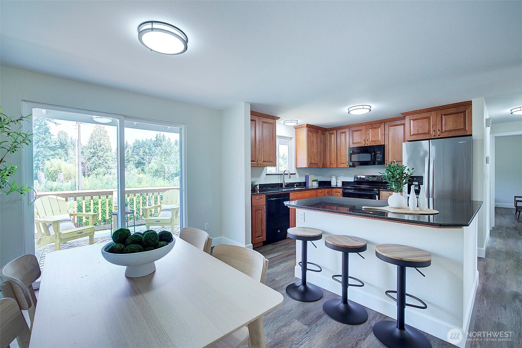 2019 181st Street Southeast Bothell, WA 98012 - Photo 6 of 23 a kitchen with stainless steel appliances a dining table chairs and a large window